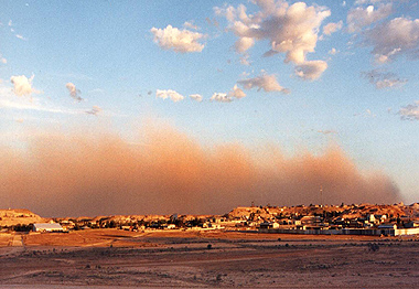 A dust storm rolls in from the south west across the township of Coober Pedy in the late afternoon
