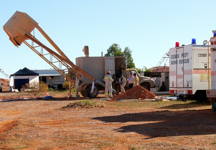 Coober Pedy Mine Rescue Squad implement an opal mining blower to assist police with extracting soil from a mine shaft in the search for missing teenager Karen Williams