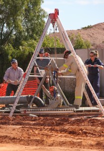 Police and Coober Pedy Mine Rescue volunteers uncover two more shafts at location on Monday - seen here entering one of the shafts