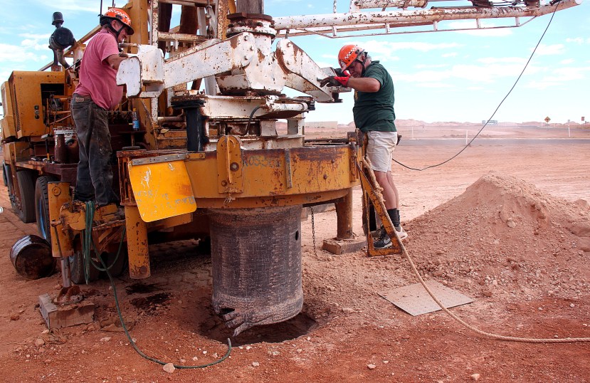 Preparing to widen a narrow mining shaft at the search site are Mine Rescue Squad Frank Novosel and Andy Sheils